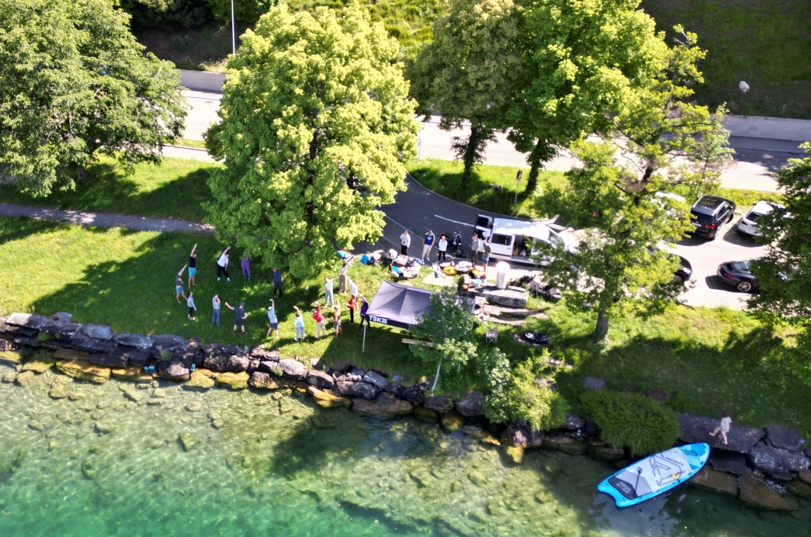 A drone photo freedivers stretching next to a lake in Zurich