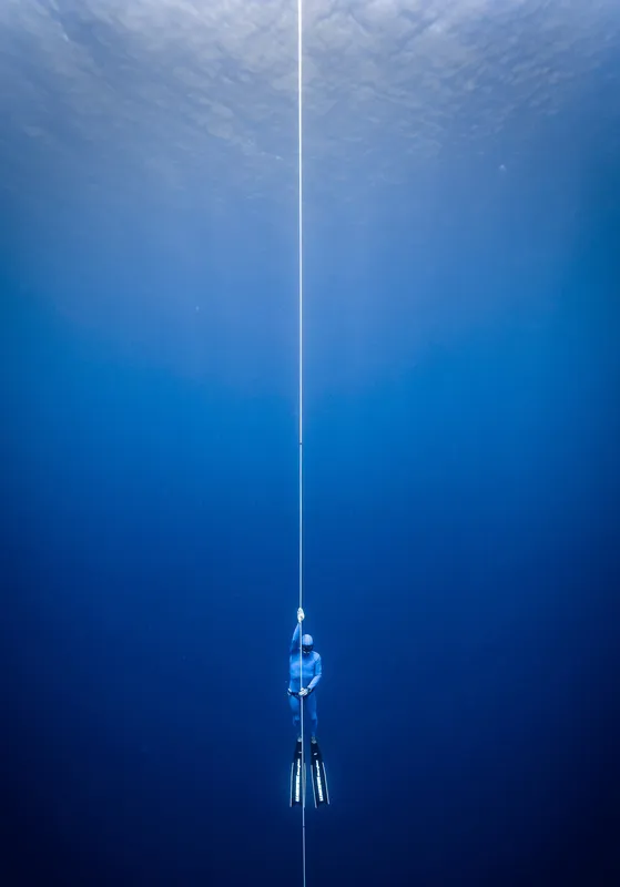 a freediver is ascending from depth
